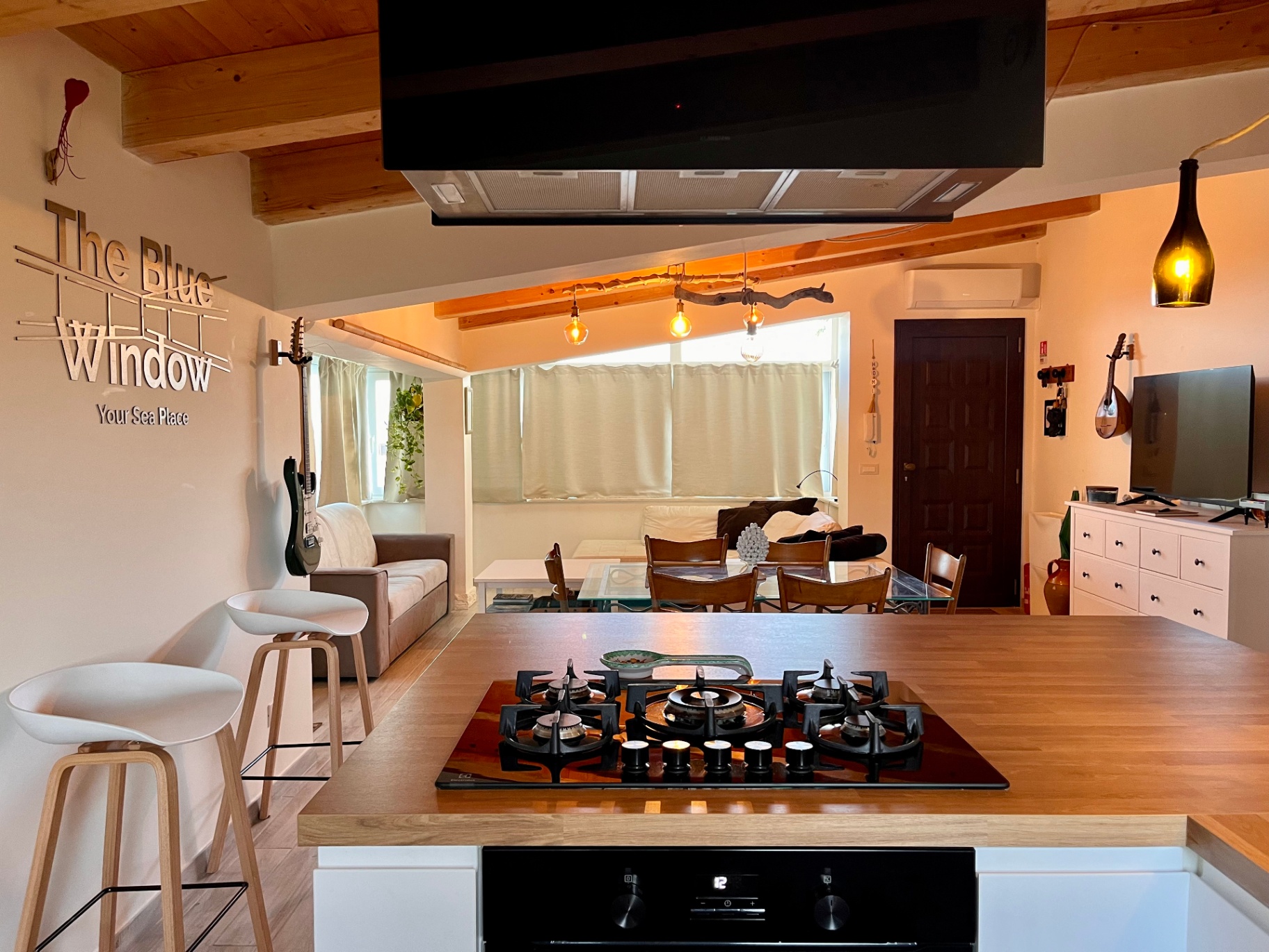 Open kitchen and living space at The Blue Window sea-view apartment, South-East Sicily